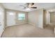 Tile floors in a bright living space with a ceiling fan and a built in shelving unit at 1472 Belcher S Rd, Largo, FL 33771