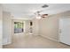 Bright living area featuring tile floors, ceiling fan, neutral walls, and sliding door to patio at 1472 Belcher S Rd, Largo, FL 33771
