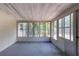Spacious screened patio featuring tile floors, ample natural light, and a view of the backyard at 1472 Belcher S Rd, Largo, FL 33771