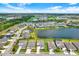 An aerial view shows houses near a lake in a Primary-planned community at 16115 Mount Holly Dr, Bradenton, FL 34211
