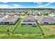 Aerial view of a spacious backyard with green lawn, black fence, and patio at 16115 Mount Holly Dr, Bradenton, FL 34211