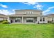 View of the backyard with a covered patio, ceiling fans and sliding glass doors at 16115 Mount Holly Dr, Bradenton, FL 34211