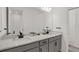 Stylish bathroom features dual sinks, gray cabinetry, modern fixtures, and a bright, clean design at 16115 Mount Holly Dr, Bradenton, FL 34211