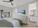 Well-lit bedroom featuring a ceiling fan, a desk and modern design at 16115 Mount Holly Dr, Bradenton, FL 34211