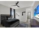 Comfortable bedroom with ceiling fan, TV, and neutral decor at 16115 Mount Holly Dr, Bradenton, FL 34211