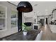 Bright dining room offers backyard views, dark wood table, and seamless flow into kitchen and living room at 16115 Mount Holly Dr, Bradenton, FL 34211