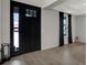 Bright entryway features a black front door, light wood floors, and modern decor at 16115 Mount Holly Dr, Bradenton, FL 34211