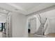 Open interior showcasing staircase with modern railings and views into adjacent rooms at 16115 Mount Holly Dr, Bradenton, FL 34211