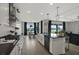 Open-concept kitchen features a central island, stainless appliances, and seamless flow into the dining area at 16115 Mount Holly Dr, Bradenton, FL 34211