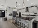 Modern kitchen with an island, sleek black countertops, and pendant lighting at 16115 Mount Holly Dr, Bradenton, FL 34211