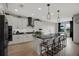 Modern kitchen boasts sleek black countertops, stainless steel appliances, and stylish pendant lighting at 16115 Mount Holly Dr, Bradenton, FL 34211