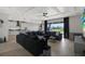 Bright living room with a coffered ceiling, a large sectional sofa, and sliding glass doors at 16115 Mount Holly Dr, Bradenton, FL 34211