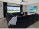 Open living room featuring a large sectional sofa, coffered ceiling, and backyard views at 16115 Mount Holly Dr, Bradenton, FL 34211