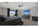 Spacious main bedroom boasts a view, a large TV, a comfortable bed, and ample natural light at 16115 Mount Holly Dr, Bradenton, FL 34211