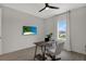 Bright home office with large window and modern furniture, providing an ideal workspace at 16115 Mount Holly Dr, Bradenton, FL 34211