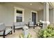 Cozy front porch with comfortable seating, a modern fire pit, and tasteful decor at 16115 Mount Holly Dr, Bradenton, FL 34211