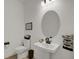 Chic powder room with modern fixtures, pedestal sink, decorative mirror, and stylish accents at 16115 Mount Holly Dr, Bradenton, FL 34211
