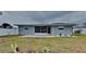 Backyard featuring a patio, well-maintained lawn, and privacy fence at 1701 Hibiscus S Cir, Oldsmar, FL 34677