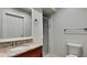 Bathroom with granite vanity top, framed mirror, and glass door standing shower at 1701 Hibiscus S Cir, Oldsmar, FL 34677