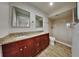 Updated bathroom featuring double sinks, granite countertops, and a modern glass-enclosed shower at 1701 Hibiscus S Cir, Oldsmar, FL 34677