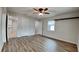 Spacious bedroom featuring wood-look floors, modern ceiling fan, and ample natural light at 1701 Hibiscus S Cir, Oldsmar, FL 34677