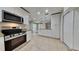 Modern kitchen with stainless steel appliances and granite countertops opens to the living spaces at 1701 Hibiscus S Cir, Oldsmar, FL 34677