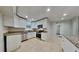 Well-lit kitchen featuring stainless steel appliances, granite countertops, and ample cabinet space at 1701 Hibiscus S Cir, Oldsmar, FL 34677