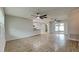 Spacious living room with wood floors, ceiling fans, and sliding glass doors leading to the lanai at 1701 Hibiscus S Cir, Oldsmar, FL 34677