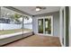 View of screened patio with sliding glass doors opening to backyard and fence at 1701 Hibiscus S Cir, Oldsmar, FL 34677