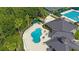 Aerial view of the community clubhouse, pool, and surrounding neighborhood at 17809 Sandpine Trace Way, Tampa, FL 33647