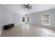 Bright bedroom features wood floors, neutral walls, a modern ceiling fan, and natural light at 17809 Sandpine Trace Way, Tampa, FL 33647