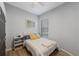 Serene bedroom featuring a soft bed, side table and natural light from the window at 17809 Sandpine Trace Way, Tampa, FL 33647