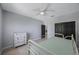 Comfortable bedroom with light grey walls, ceiling fan, and closet at 17809 Sandpine Trace Way, Tampa, FL 33647