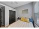 Comfortable bedroom featuring a bed, a mirror and bright window at 17809 Sandpine Trace Way, Tampa, FL 33647