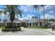 View of the clubhouse with palm trees and landscaping at 17809 Sandpine Trace Way, Tampa, FL 33647