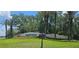 Lush landscaping surrounds the Arbor Greene community entrance sign on a sunny day at 17809 Sandpine Trace Way, Tampa, FL 33647