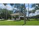 Picturesque community gazebo nestled among mature trees, offering a serene spot for relaxation and gatherings at 17809 Sandpine Trace Way, Tampa, FL 33647