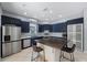 Beautiful kitchen with stainless steel appliances, dark cabinetry and a spacious center island with barstool seating at 17809 Sandpine Trace Way, Tampa, FL 33647