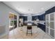 Beautiful kitchen featuring tile floors, blue cabinets, stainless steel appliances and a kitchen island at 17809 Sandpine Trace Way, Tampa, FL 33647