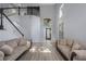 Bright living room with high ceilings, light wood floors, and a staircase at 17809 Sandpine Trace Way, Tampa, FL 33647