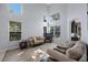 Bright living room with high ceilings, many windows, hardwood floors, and comfortable furniture at 17809 Sandpine Trace Way, Tampa, FL 33647