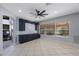 Open-concept living room featuring stylish blue built-in cabinets and an abundance of natural light at 17809 Sandpine Trace Way, Tampa, FL 33647