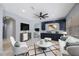 Bright living room with custom cabinets, tile floors, stylish furniture, and modern ceiling fan at 17809 Sandpine Trace Way, Tampa, FL 33647