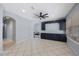 Spacious living room with blue built-in shelving, tile floors, neutral walls and large windows at 17809 Sandpine Trace Way, Tampa, FL 33647