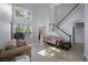 Bright living room with high ceilings, many windows, hardwood floors, and comfortable furniture at 17809 Sandpine Trace Way, Tampa, FL 33647