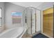 Bright bathroom featuring a soaking tub and a glass-enclosed shower at 17809 Sandpine Trace Way, Tampa, FL 33647