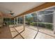 Enjoy relaxing outdoors on this screened patio with a tiled floor and views of the lush backyard at 17809 Sandpine Trace Way, Tampa, FL 33647