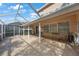 A screened patio provides shade and a comfortable place to relax outdoors at 17809 Sandpine Trace Way, Tampa, FL 33647