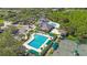 Aerial view of the neighborhood pool with tennis courts and covered seating areas at 17809 Sandpine Trace Way, Tampa, FL 33647