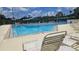 Community swimming pool with ample seating and a sunny atmosphere at 17809 Sandpine Trace Way, Tampa, FL 33647